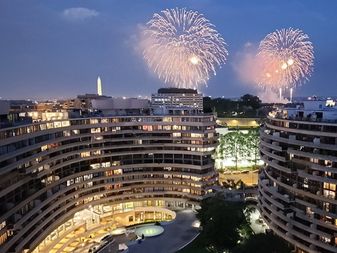 View of the Watergate Hotel with fireworks and the Washington Monument in the background